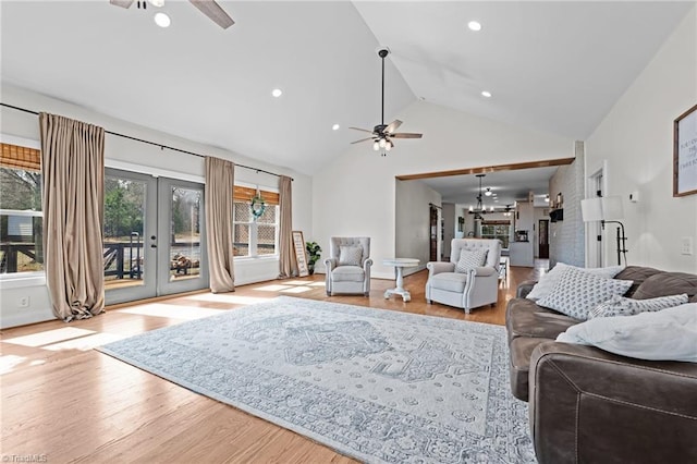4420 Bunton Swaim Rd, Liberty, NC 27298 - living area featuring ceiling fan with notable chandelier, french doors, high vaulted ceiling, and wood finished floors