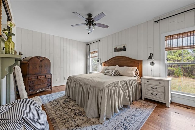 4420 Bunton Swaim Rd, Liberty, NC 27298 - bedroom with multiple windows, wood finished floors, visible vents, and ceiling fan