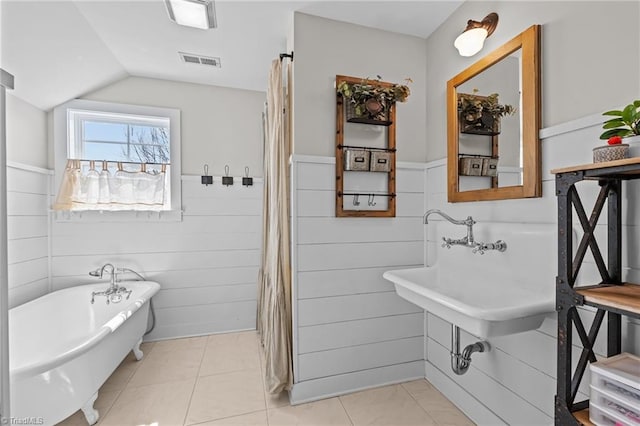 4420 Bunton Swaim Rd, Liberty, NC 27298 - full bath with a wainscoted wall, vaulted ceiling, a freestanding tub, and visible vents