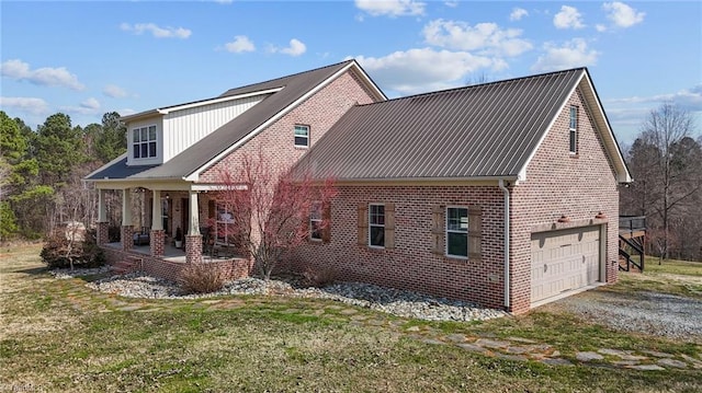4420 Bunton Swaim Rd, Liberty, NC 27298 - view of property exterior featuring gravel driveway, a yard, an attached garage, brick siding, and metal roof