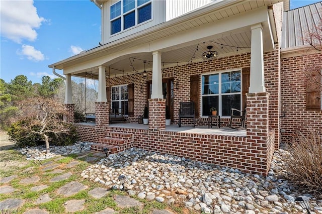 4420 Bunton Swaim Rd, Liberty, NC 27298 - view of exterior entry featuring brick siding and a porch