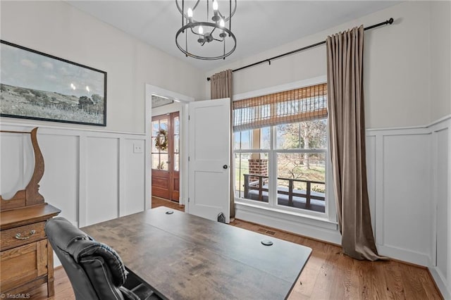 4420 Bunton Swaim Rd, Liberty, NC 27298 - office featuring light wood-style flooring, a notable chandelier, visible vents, and a decorative wall