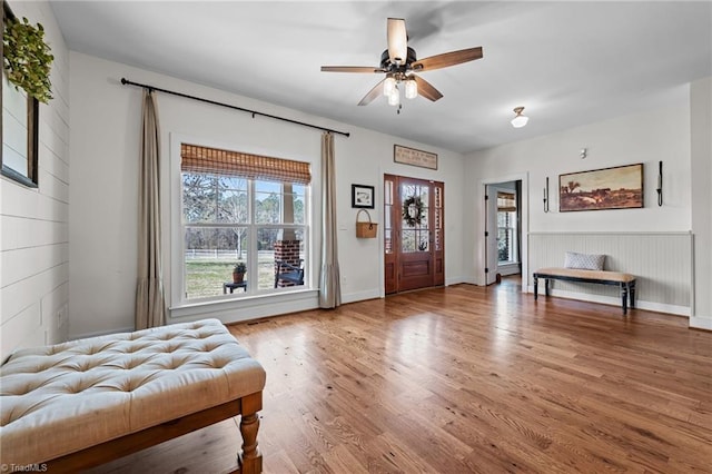 4420 Bunton Swaim Rd, Liberty, NC 27298 - foyer entrance with wooden walls, ceiling fan, and wood finished floors