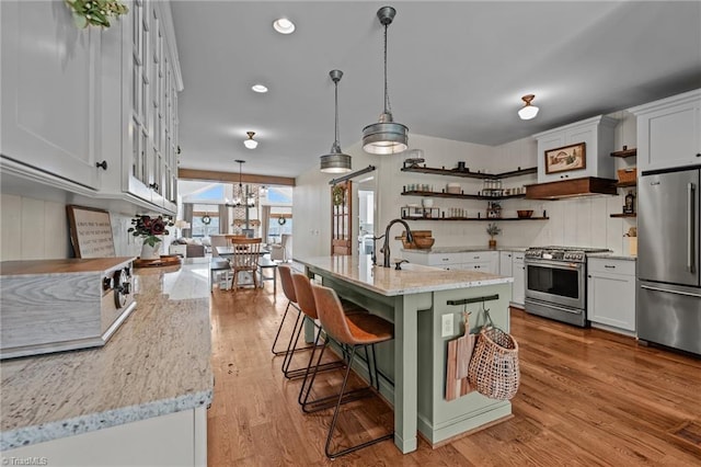 4420 Bunton Swaim Rd, Liberty, NC 27298 - kitchen featuring white cabinetry, open shelves, light wood-style floors, and appliances with stainless steel finishes