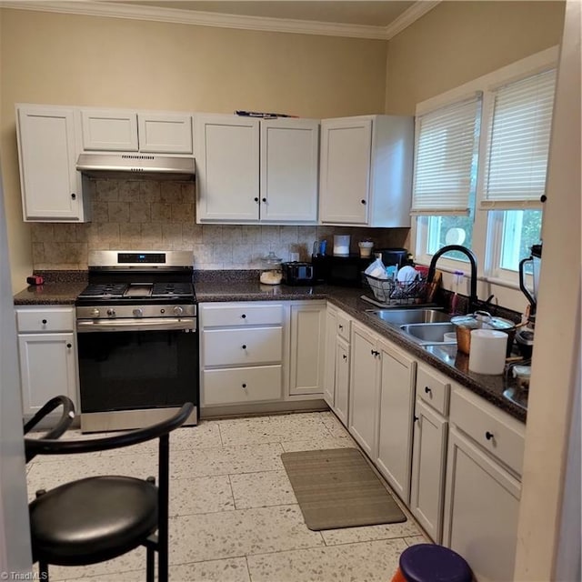 kitchen with gas range, crown molding, tasteful backsplash, and white cabinets