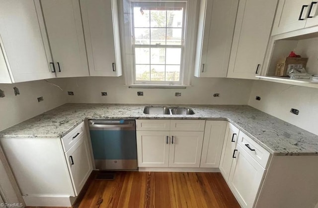 kitchen with dishwasher, light stone counters, wood finished floors, and white cabinets