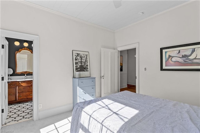 carpeted bedroom with ornamental molding, connected bathroom, a ceiling fan, and baseboards