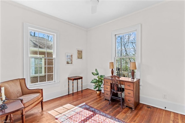 home office with baseboards, hardwood / wood-style flooring, and crown molding