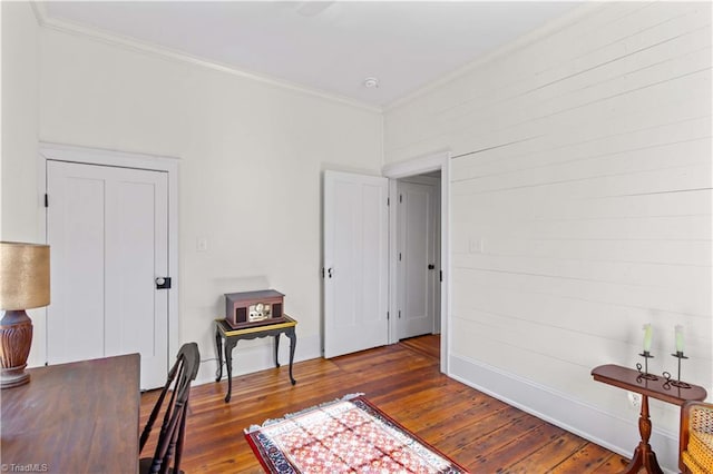 home office featuring ornamental molding and hardwood / wood-style floors