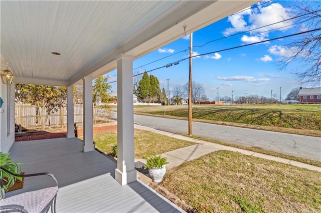 view of patio / terrace featuring covered porch and fence