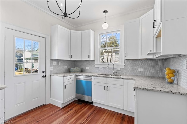 kitchen with wood finished floors, a sink, white cabinetry, ornamental molding, and dishwasher