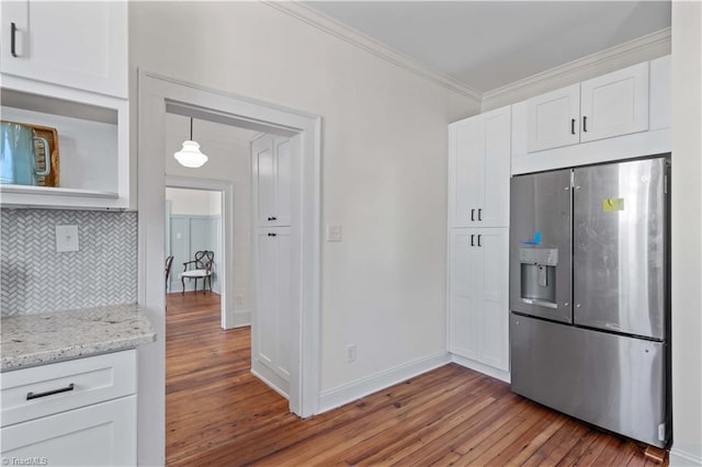 kitchen featuring light wood-style flooring, white cabinets, ornamental molding, stainless steel refrigerator with ice dispenser, and decorative backsplash