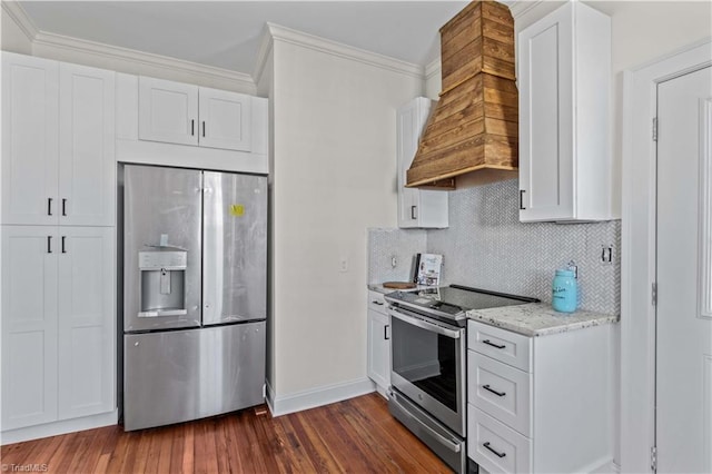 kitchen with ornamental molding, appliances with stainless steel finishes, dark wood-type flooring, and premium range hood