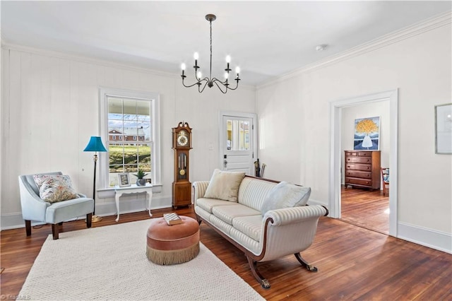 living area with an inviting chandelier, baseboards, ornamental molding, and dark wood-style flooring