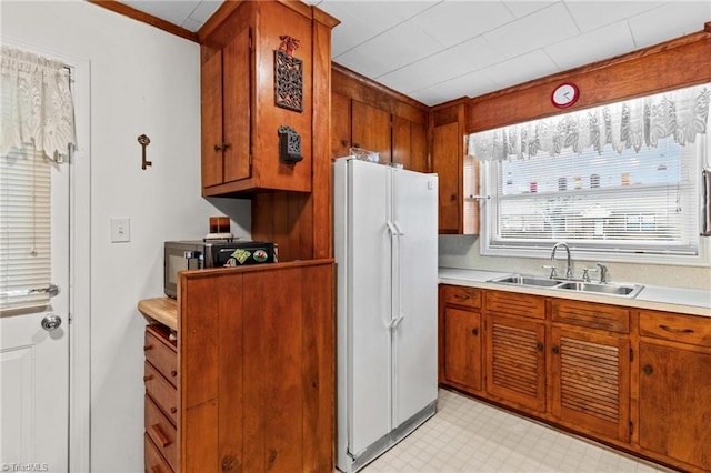 kitchen featuring white refrigerator and sink