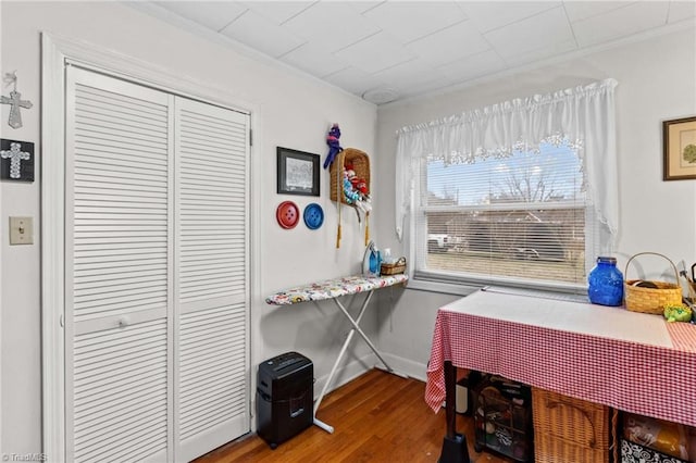 office with wood-type flooring and crown molding