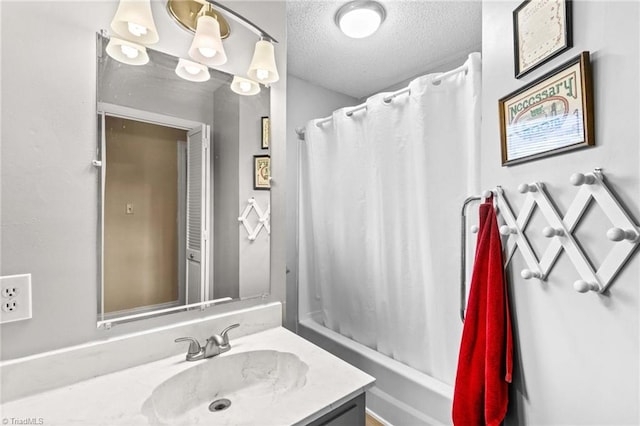 bathroom with vanity, a textured ceiling, and shower / bath combo