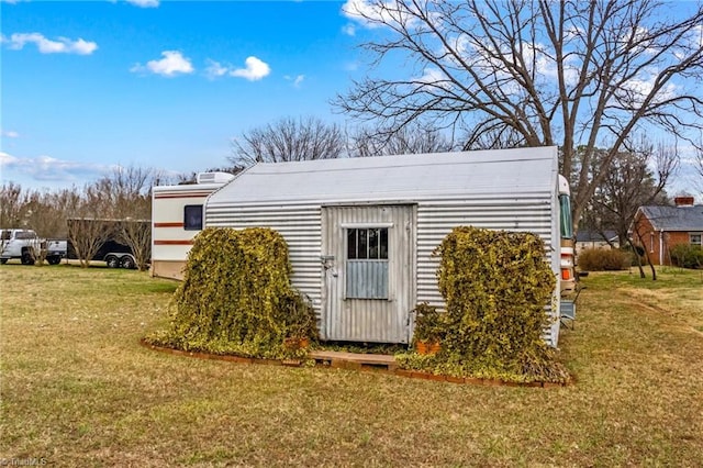 view of outbuilding featuring a lawn