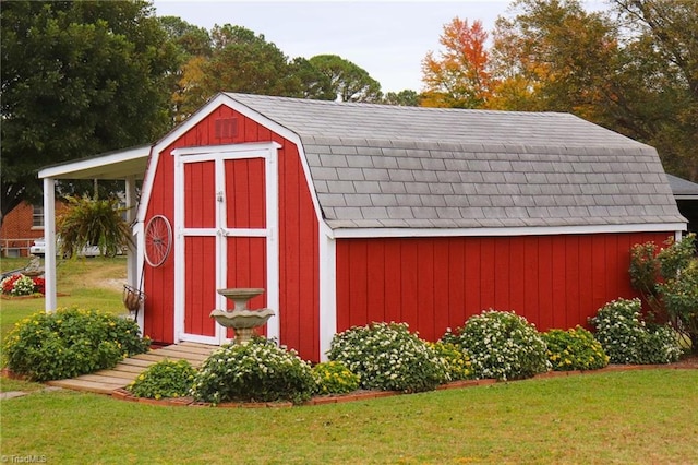 view of outbuilding featuring a lawn