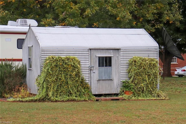 view of outbuilding featuring a yard