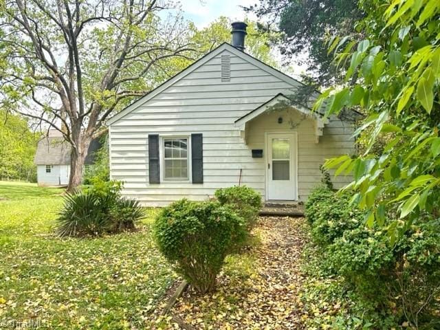 back of property featuring a lawn