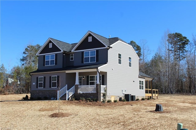 view of front of home with a porch and central AC