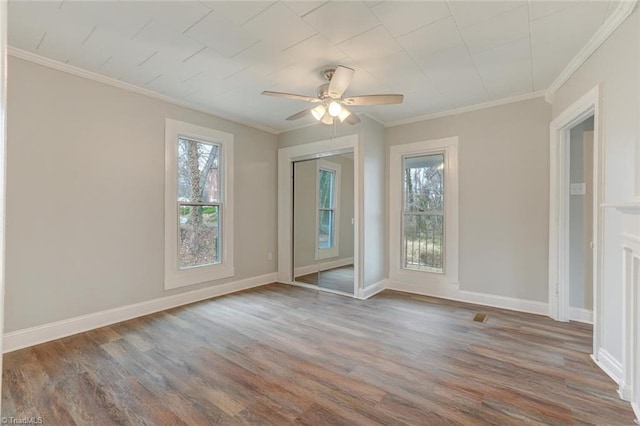 spare room featuring hardwood / wood-style floors, ceiling fan, and ornamental molding