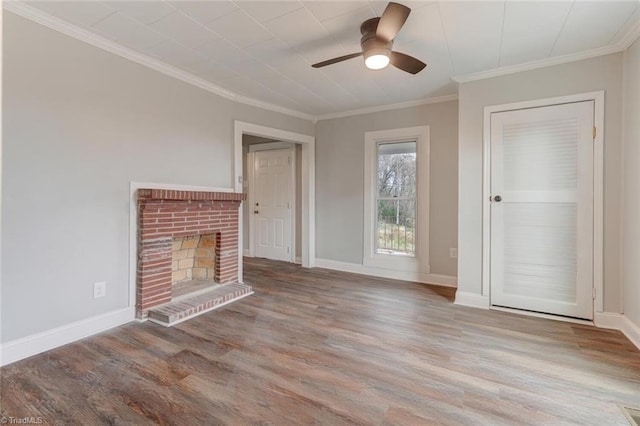 unfurnished living room featuring a brick fireplace, ceiling fan, crown molding, and light hardwood / wood-style flooring