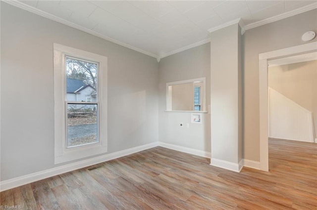 empty room with light hardwood / wood-style flooring and crown molding