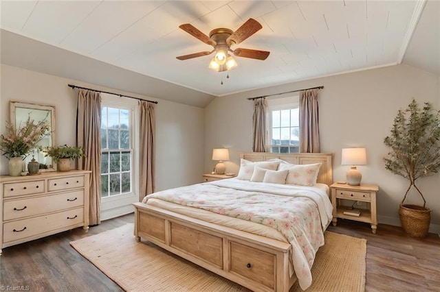 bedroom featuring ceiling fan, dark hardwood / wood-style floors, lofted ceiling, and ornamental molding