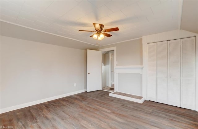 unfurnished bedroom with hardwood / wood-style flooring, ceiling fan, lofted ceiling, and a closet