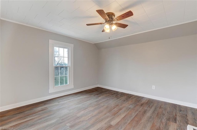 empty room featuring ornamental molding, lofted ceiling, ceiling fan, and dark wood-type flooring