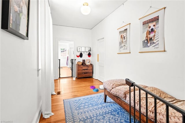 bedroom with baseboards and wood finished floors