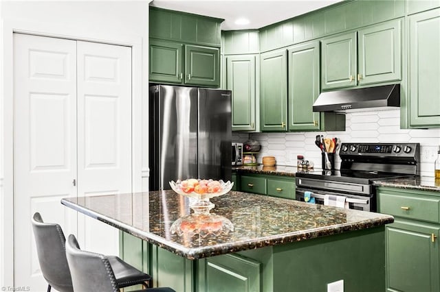 kitchen with under cabinet range hood, stainless steel appliances, and green cabinets