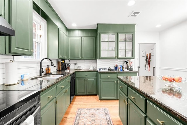kitchen featuring a sink, green cabinets, and visible vents