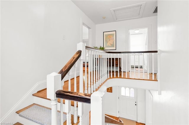 stairs with baseboards and visible vents