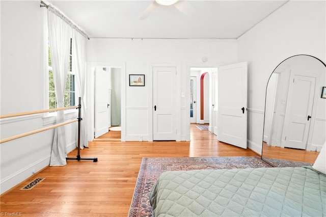 bedroom with a ceiling fan, baseboards, visible vents, and light wood-style flooring