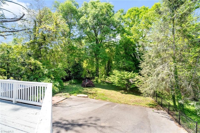 view of patio with fence and a wooden deck