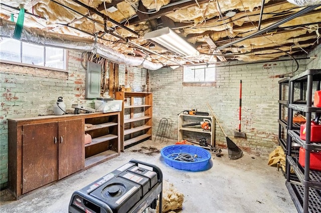basement with brick wall and electric panel