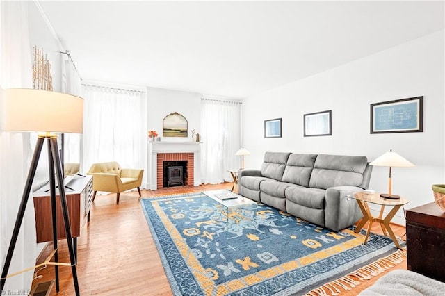 living room with wood finished floors and a fireplace