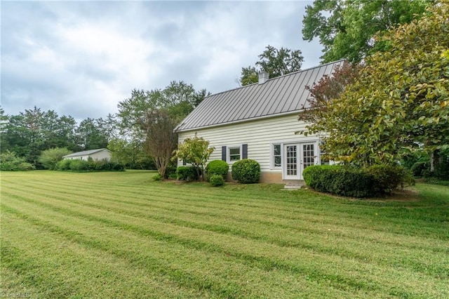3775 Friendship Ledford Rd, Winston-Salem, NC 27107 - rear view of house with french doors, a chimney, a standing seam roof, metal roof, and a lawn
