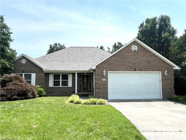 104 Autumn Hill Ct, Archdale, NC 27263 - view of front facade with brick siding, an attached garage, a front yard, concrete driveway, and a shingled roof
