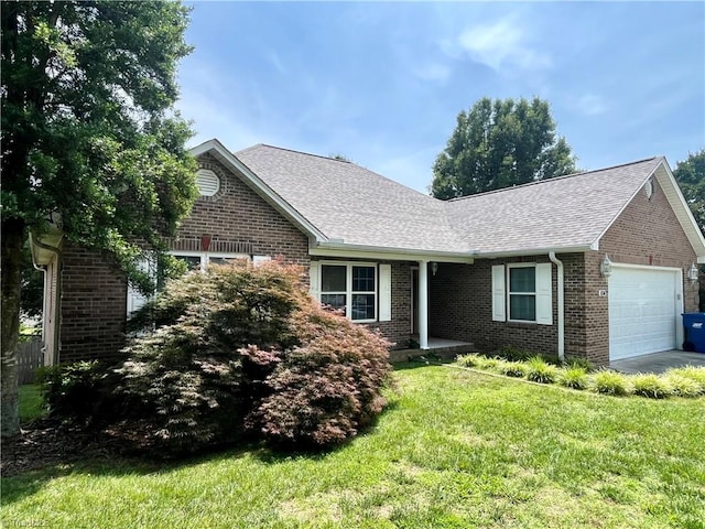 104 Autumn Hill Ct, Archdale, NC 27263 - view of front of house featuring an attached garage, brick siding, a front lawn, and a shingled roof