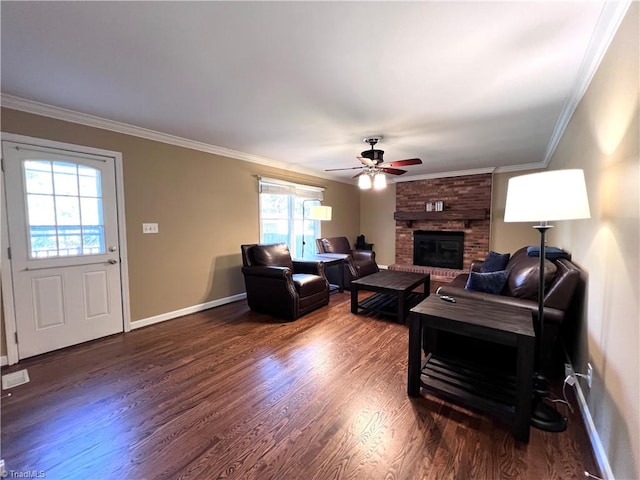 living room featuring ceiling fan, dark hardwood / wood-style flooring, ornamental molding, and a brick fireplace