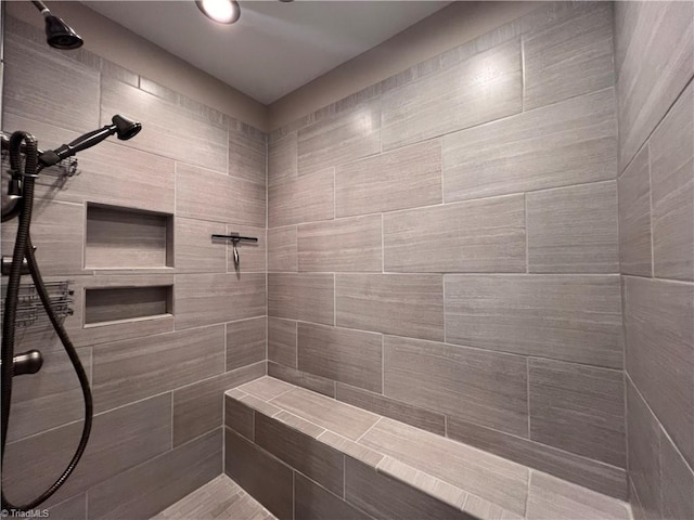 bathroom with tiled shower