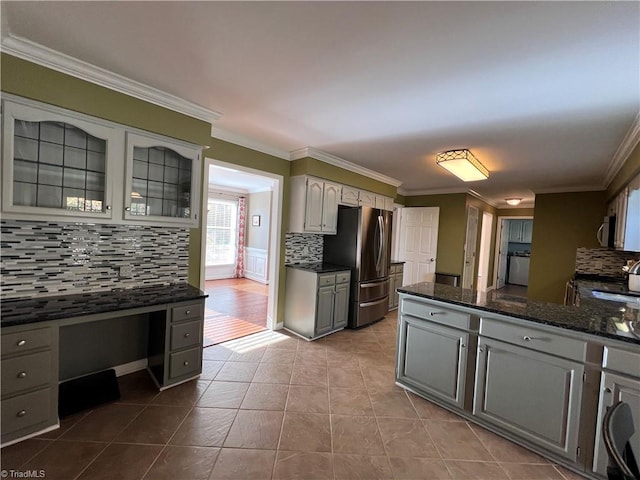 kitchen featuring appliances with stainless steel finishes, backsplash, crown molding, and gray cabinetry