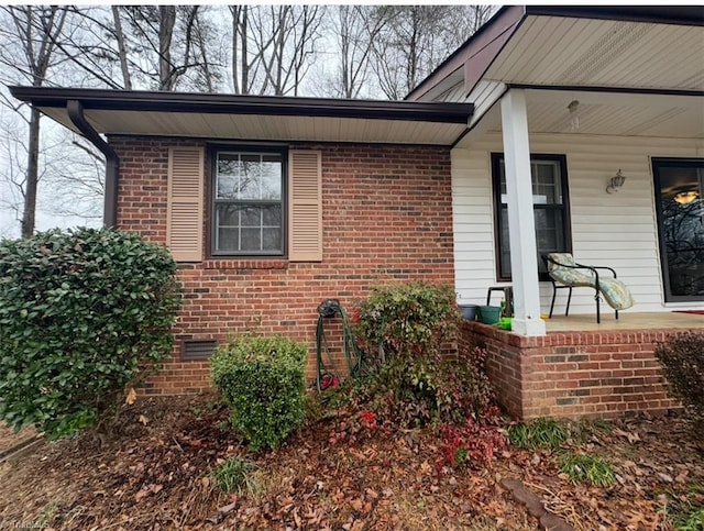 5687 Bull Run Rd, Winston-Salem, NC 27106 - property entrance featuring a porch, crawl space, and brick siding