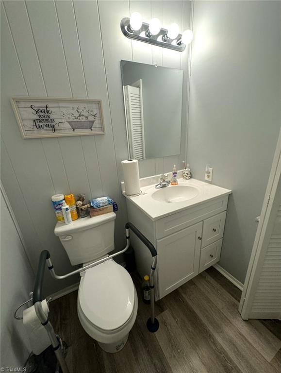 5687 Bull Run Rd, Winston-Salem, NC 27106 - half bathroom with wood finished floors and vanity