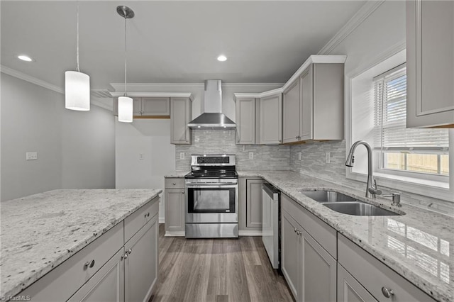 kitchen featuring gray cabinetry, light stone countertops, sink, wall chimney range hood, and appliances with stainless steel finishes