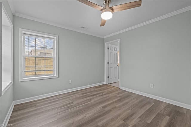 unfurnished room featuring crown molding, light hardwood / wood-style flooring, and ceiling fan